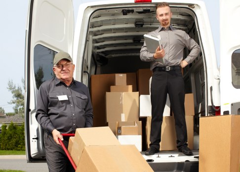 Loading boxes and furniture into a moving van in Belsizepark