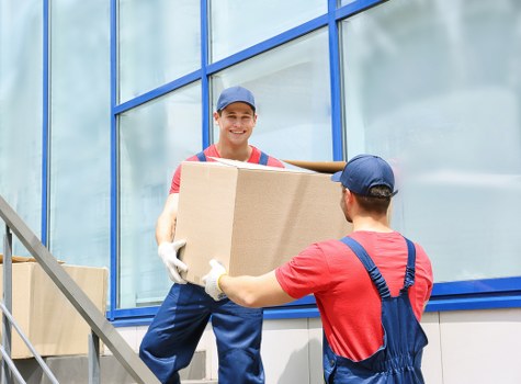 Office relocation planning in Belsizepark with moving boxes and workspace equipment