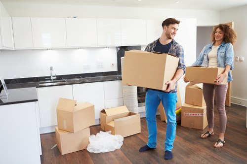 Moving boxes and removal team preparing a UK home move