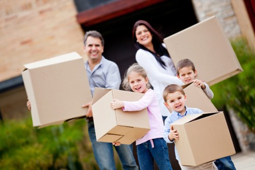 Careful movers carrying furniture through a period property staircase